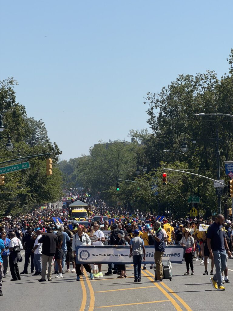 Marchers with a New York Attorney General banner at the Labor Day parade, Washington Avenue, September 7, 2026